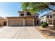 Inviting two-story home with a spacious three-car garage, long driveway, and a lovely tree at 2918 E Silverbell Rd, San Tan Valley, AZ 85143