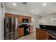 Modern kitchen featuring stainless steel appliances, wood cabinets, and black countertops at 2918 E Silverbell Rd, San Tan Valley, AZ 85143