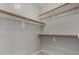 Walk-in closet with multiple shelves and wooden rods for ample storage space at 2918 E Silverbell Rd, San Tan Valley, AZ 85143