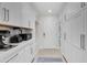 Laundry room with plenty of cabinet and counter space with stacked washer and dryer units at 3038 E Stella Ln, Phoenix, AZ 85016