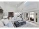 Open-concept living room with high ceilings, neutral decor, and a glimpse into the modern, white kitchen at 3038 E Stella Ln, Phoenix, AZ 85016
