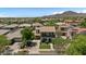 Aerial view of luxurious homes featuring lush landscaping, mature trees, and terracotta-colored roofs at 3042 N Beverly Pl, Buckeye, AZ 85396