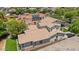 Aerial view of Southwestern home featuring Spanish tile roof, neutral stucco, and well-manicured lawn at 3042 N Beverly Pl, Buckeye, AZ 85396