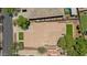 Aerial view of home with pool, landscaped backyard, lush trees, and concrete driveway at 3042 N Beverly Pl, Buckeye, AZ 85396