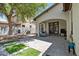 Spacious backyard with a stone patio, and a shaded lounge area perfect for entertaining at 3042 N Beverly Pl, Buckeye, AZ 85396