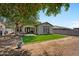 Backyard with synthetic grass, covered patio, privacy walls, and plenty of shade at 3042 N Beverly Pl, Buckeye, AZ 85396
