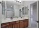 Bathroom features a double sink vanity, large mirror, and a doorway leading to another room at 3042 N Beverly Pl, Buckeye, AZ 85396