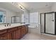 Bright bathroom with double sinks, a separate tub, and a walk-in shower at 3042 N Beverly Pl, Buckeye, AZ 85396