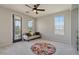Comfortable bedroom featuring a neutral color scheme, ceiling fan, balcony access and natural lighting at 3042 N Beverly Pl, Buckeye, AZ 85396