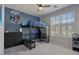 Bedroom features a lofted bed, a blue gaming chair, and a window with blinds at 3042 N Beverly Pl, Buckeye, AZ 85396