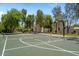 Community badminton/basketball court featuring mature trees and beautiful landscaping in background at 3042 N Beverly Pl, Buckeye, AZ 85396
