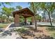 Community patio featuring a picnic area with a pergola structure, a grassy area, and trees at 3042 N Beverly Pl, Buckeye, AZ 85396