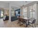 Open concept dining area with a modern table and seating, adjacent to a cozy living space at 3042 N Beverly Pl, Buckeye, AZ 85396
