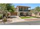 Charming two-story home features a cozy balcony, arched entryway, lush landscaping, and inviting curb appeal at 3042 N Beverly Pl, Buckeye, AZ 85396