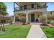 Charming two-story home features a cozy balcony, arched entryway, lush landscaping, and inviting curb appeal at 3042 N Beverly Pl, Buckeye, AZ 85396