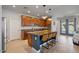 Modern eat-in kitchen with granite countertops, stainless appliances, island with seating and pendant lights at 3042 N Beverly Pl, Buckeye, AZ 85396