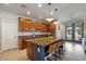 Bright kitchen featuring stainless appliances, an island with barstool seating, and hardwood floors at 3042 N Beverly Pl, Buckeye, AZ 85396