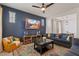 Cozy living room with a modern ceiling fan, a mounted TV, and stylish decor at 3042 N Beverly Pl, Buckeye, AZ 85396