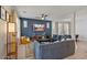 Open concept living room shows stylish furnishings, a ceiling fan, and hardwood floors at 3042 N Beverly Pl, Buckeye, AZ 85396