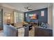 Stylish living room with blue accent wall, comfortable seating, modern lighting, and an inviting atmosphere at 3042 N Beverly Pl, Buckeye, AZ 85396