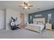 Spacious main bedroom with a large window, neutral carpet, ceiling fan and accent wall at 3042 N Beverly Pl, Buckeye, AZ 85396