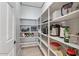 Spacious pantry with ample shelving for storage, featuring an organized layout and modern design at 3042 N Beverly Pl, Buckeye, AZ 85396