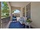 Comfortable outdoor seating with a blue rug, chairs, and sofa on a covered porch at 3042 N Beverly Pl, Buckeye, AZ 85396