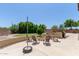 Outdoor patio with fire pit, comfortable seating, grill, and lush landscaping at 3177 S Sierra St, Gilbert, AZ 85295