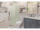 Bathroom featuring modern vanity, framed glass shower, decorated shelving, and tile flooring at 3177 S Sierra St, Gilbert, AZ 85295