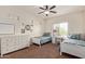 Bedroom featuring two twin beds, a ceiling fan, neutral color paint, and a large window at 3177 S Sierra St, Gilbert, AZ 85295
