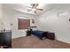 Cozy bedroom featuring a ceiling fan, carpet flooring and a bed facing the large window at 3177 S Sierra St, Gilbert, AZ 85295