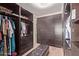 Walk-in closet with custom shelving, hanging space, a bench and carpeted floors at 3177 S Sierra St, Gilbert, AZ 85295