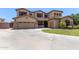 Stunning two-story home features a three car garage, stone accents, and mature landscaping at 3177 S Sierra St, Gilbert, AZ 85295