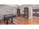 Game room with foosball table, colorful rug, hardwood floors and built in bookshelves at 3177 S Sierra St, Gilbert, AZ 85295