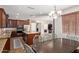 Eat-in kitchen with stainless appliances, granite counters, island, and dark wood cabinetry at 3177 S Sierra St, Gilbert, AZ 85295