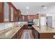 Modern kitchen featuring granite countertops, custom cabinetry, stainless steel appliances and backsplash at 3177 S Sierra St, Gilbert, AZ 85295