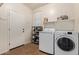 Well-equipped laundry room featuring white appliances and ample shelving for storage and organization at 3177 S Sierra St, Gilbert, AZ 85295