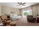 Spacious main bedroom featuring a ceiling fan, sitting area, and private balcony access at 3177 S Sierra St, Gilbert, AZ 85295