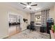 Bright office space with ceiling fan, large window and a view into the living room at 3177 S Sierra St, Gilbert, AZ 85295