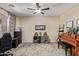 Comfortable home office with ceiling fan, light colored walls, and natural light from window at 3177 S Sierra St, Gilbert, AZ 85295