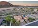 Aerial view of desert homes with solar panels, landscaped yards and mountain views at 32359 N 129Th Dr, Peoria, AZ 85383
