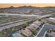 Aerial shot captures the home's scenic location, backing to mountains, open spaces and neighborhood amenities at 32359 N 129Th Dr, Peoria, AZ 85383