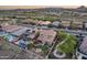 Aerial view of desert homes with solar panels, pool, fire pit, landscaping, and neighborhood streets at 32359 N 129Th Dr, Peoria, AZ 85383