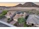Aerial view of desert homes, one with solar panels, showcasing desert landscaping and tiled roofs at 32359 N 129Th Dr, Peoria, AZ 85383