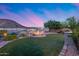 Backyard with a modern fire pit, landscaping, and a lake view at 32359 N 129Th Dr, Peoria, AZ 85383
