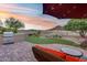 Well-maintained backyard featuring a built-in grill, cozy fire pit, and lush artificial turf with a seating area for entertainment at 32359 N 129Th Dr, Peoria, AZ 85383