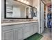 Well-lit bathroom with double sinks, decorative mirror and access to a walk-in closet at 32359 N 129Th Dr, Peoria, AZ 85383