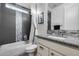 Modern bathroom features a shower-over-tub, granite countertop, and sleek tile at 32359 N 129Th Dr, Peoria, AZ 85383