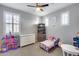 Charming bedroom featuring neutral walls, a ceiling fan, and ample storage and play space at 32359 N 129Th Dr, Peoria, AZ 85383