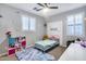 Bright bedroom with a comfy rug, ceiling fan, and ample play and storage space for your  at 32359 N 129Th Dr, Peoria, AZ 85383